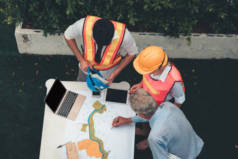 Construction workers analyzing plans